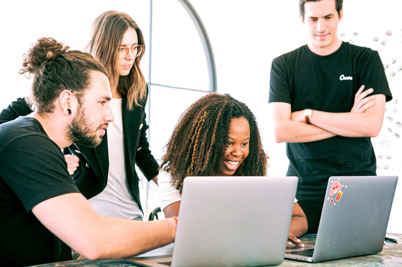 A group of employees collaborating at a table demonstrating active employee engagement